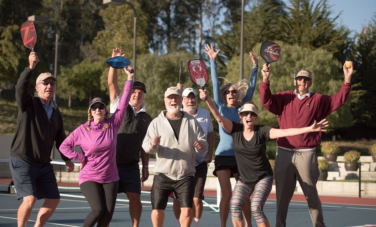 Members cheering on a pickleball court