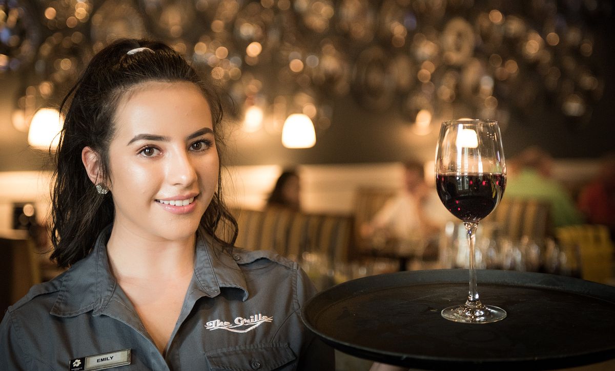 Waitress serving wine at Trilogy Orlando